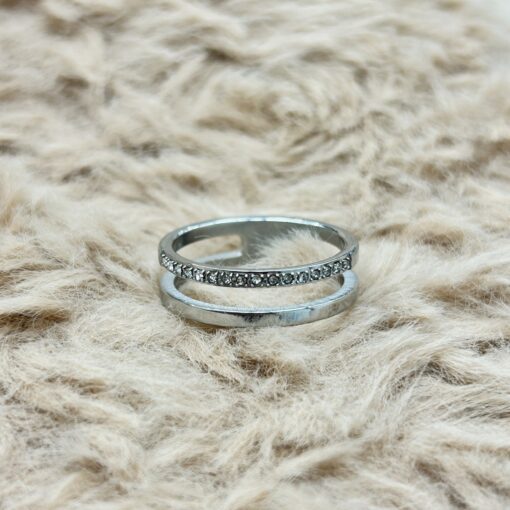Minimalist Silver Pave Zircon Double Layer Ring picture2 - Eriy Gift Two silver rings resting on soft beige fur, one with small stones along the band.