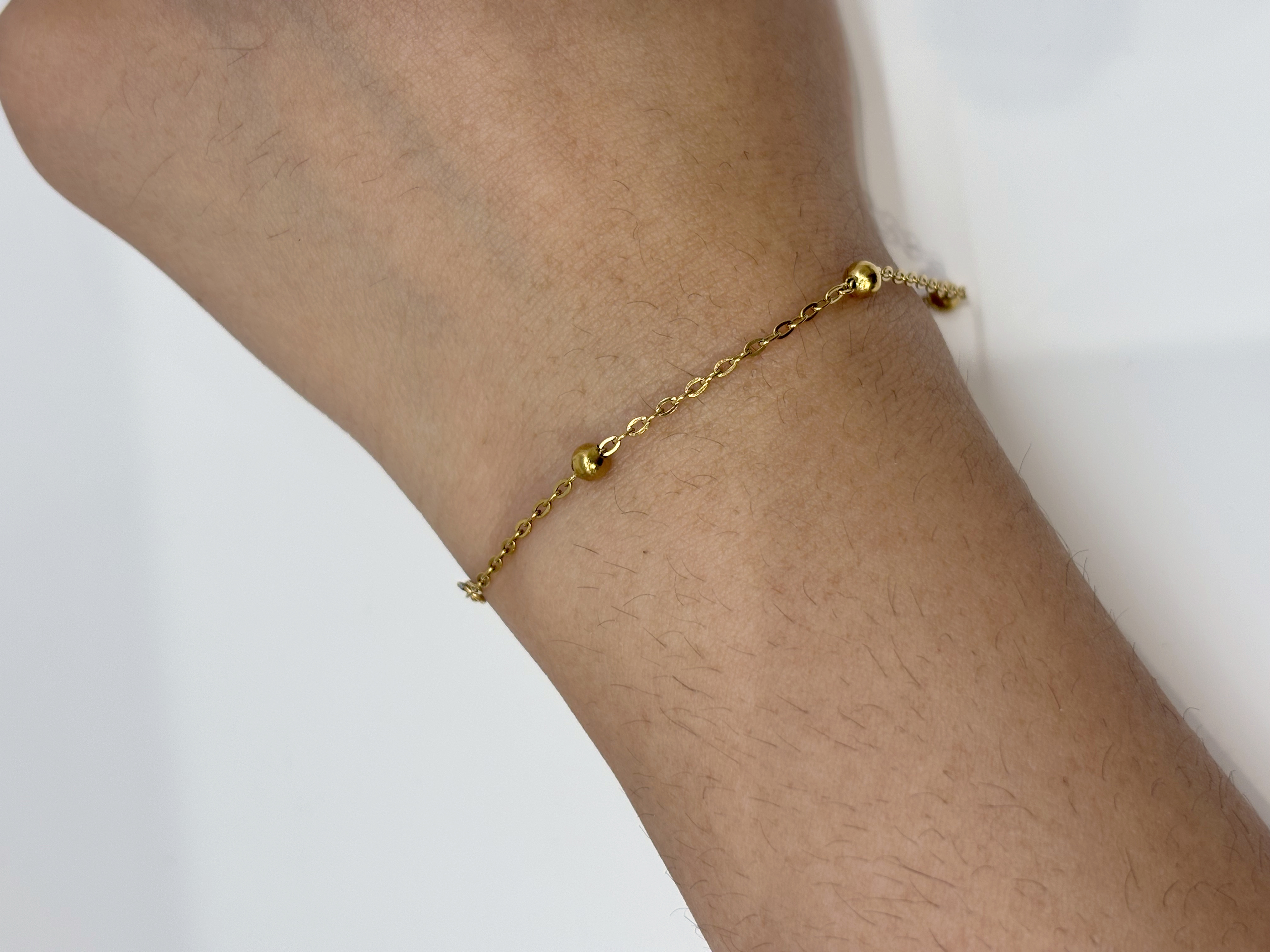 Beaded Satellite Chain gold plated bracelet worn on wrist