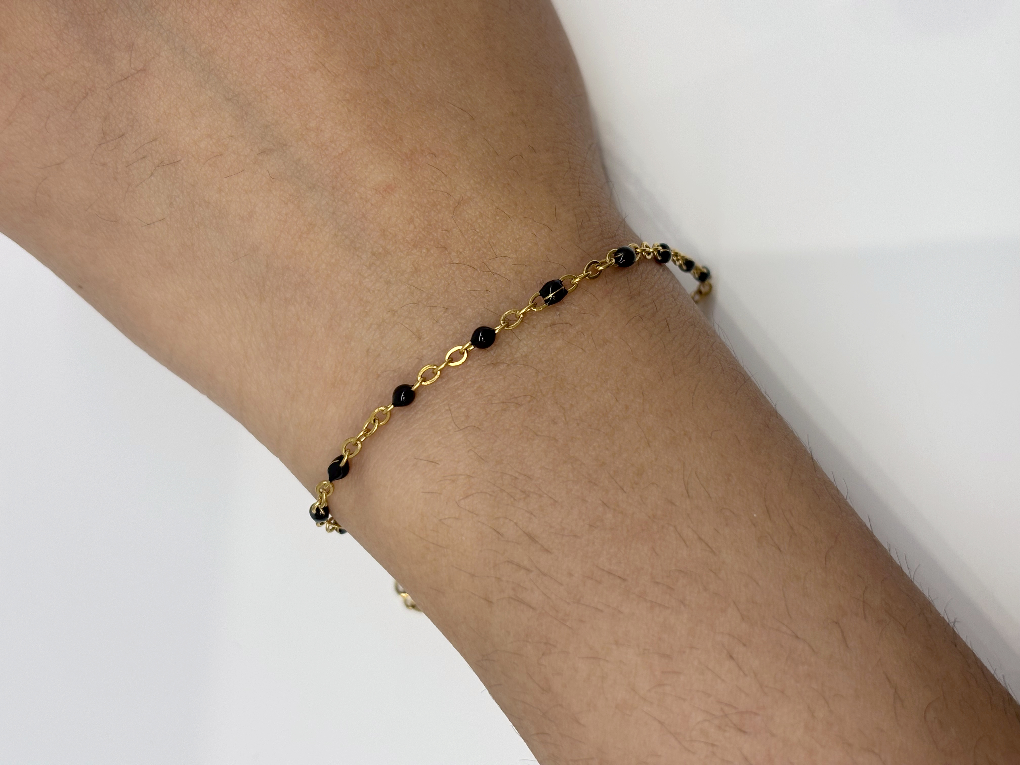Black and Gold Bead gold plated bracelet worn on wrist