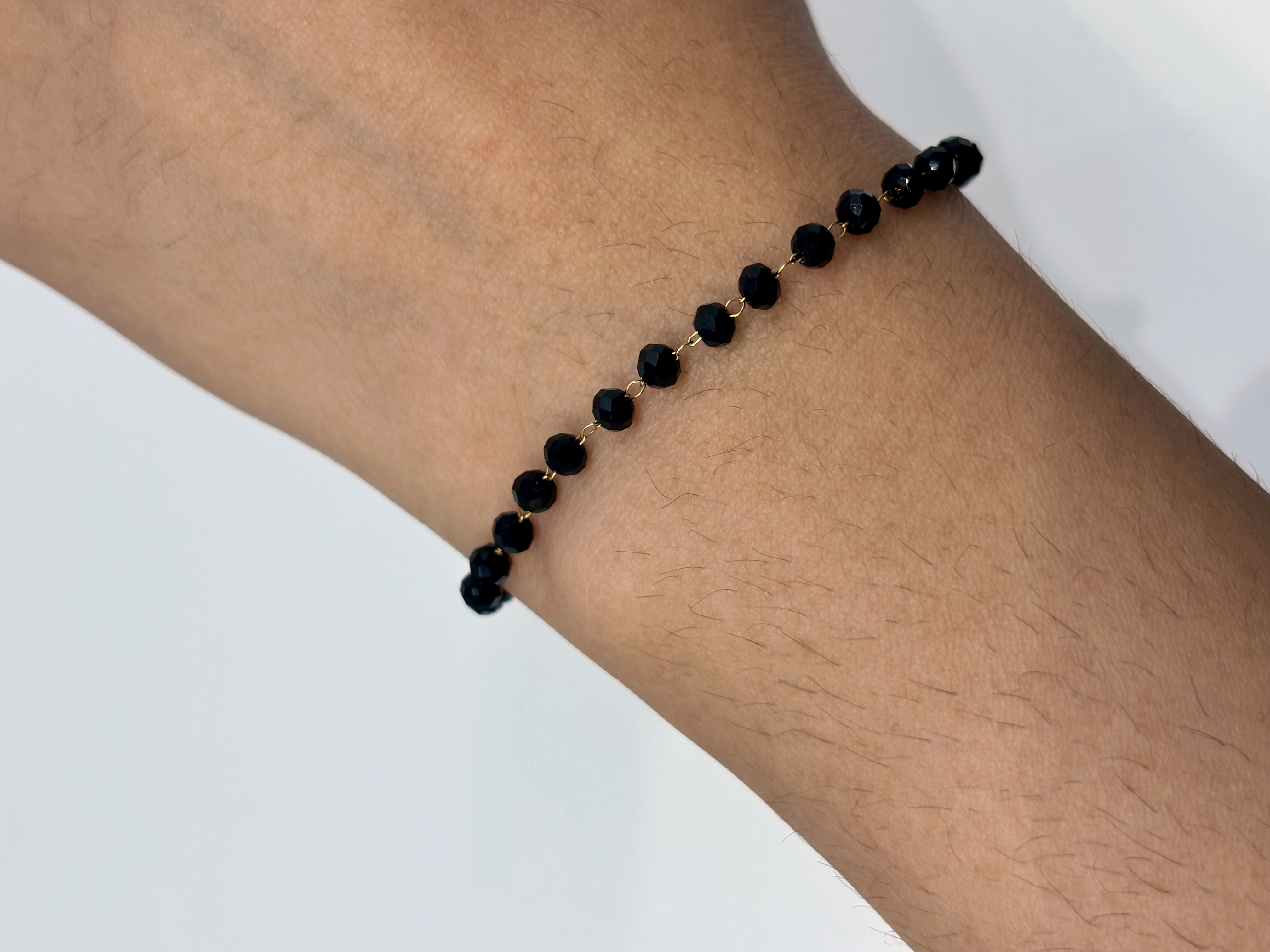 Black Bead gold plated bracelet worn on wrist