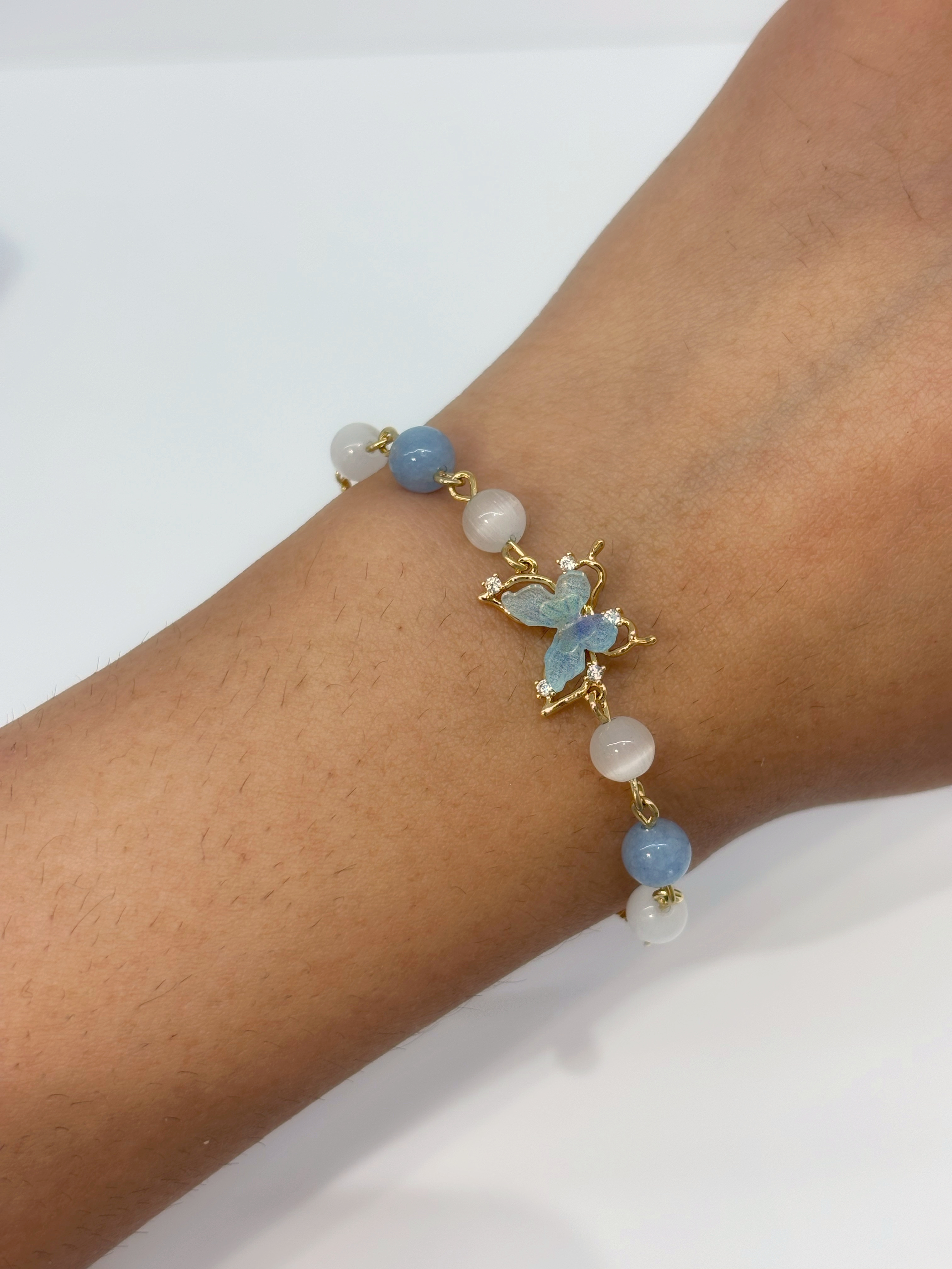 Blue Celestial gold plated bracelet worn on wrist
