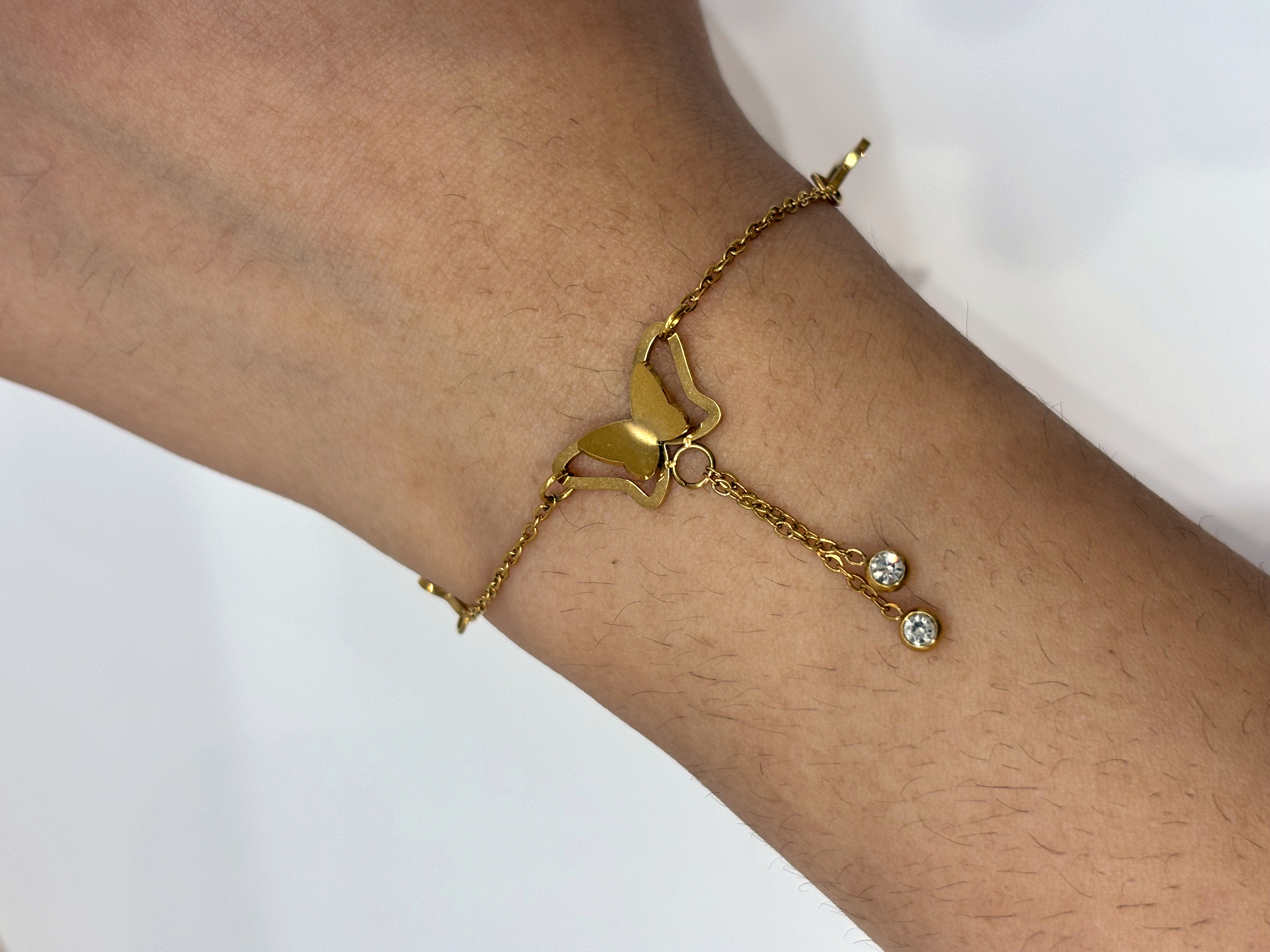 Butterfly Charm gold plated bracelet worn on wrist