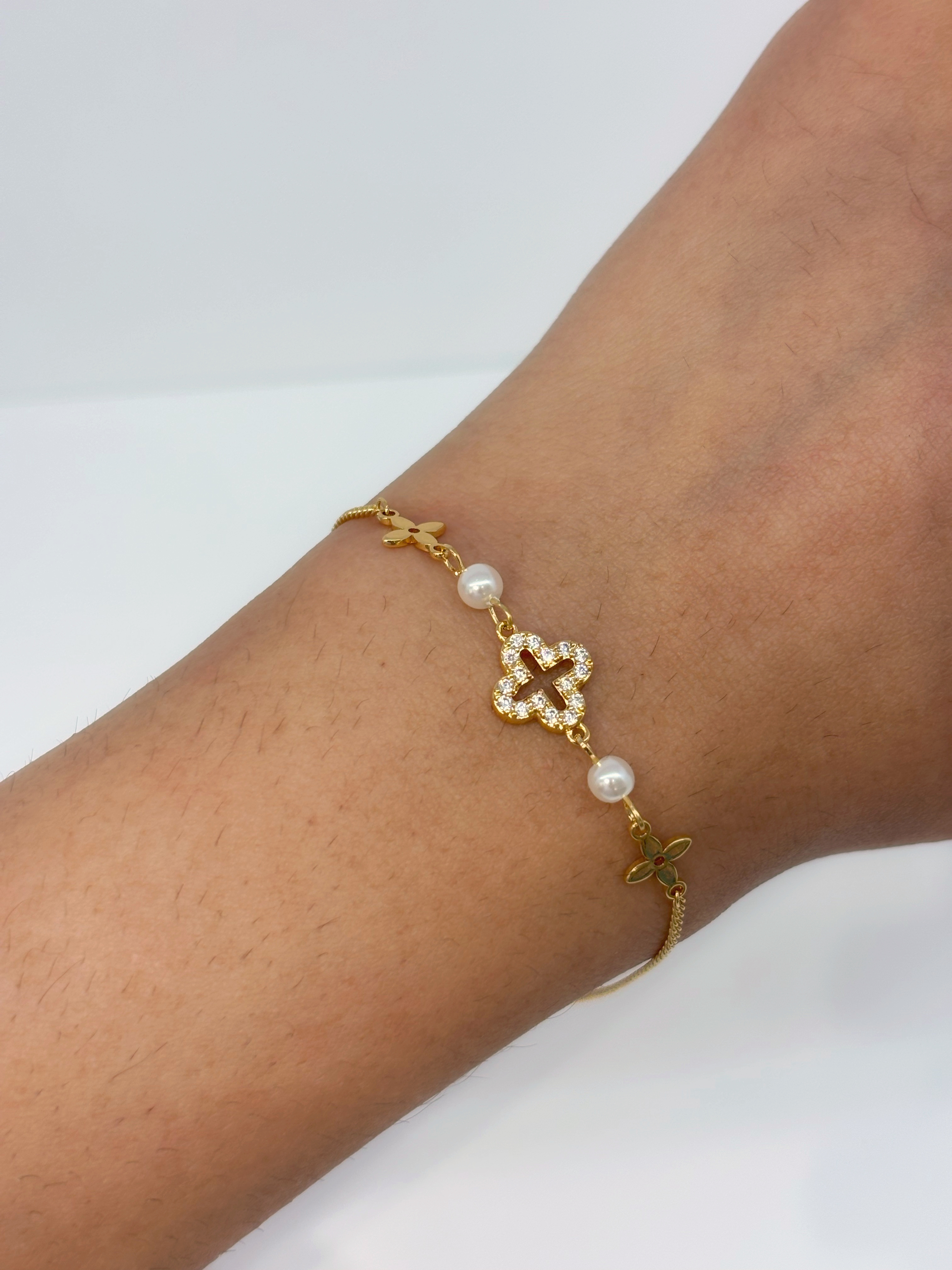 Clover Station gold plated bracelet worn on wrist