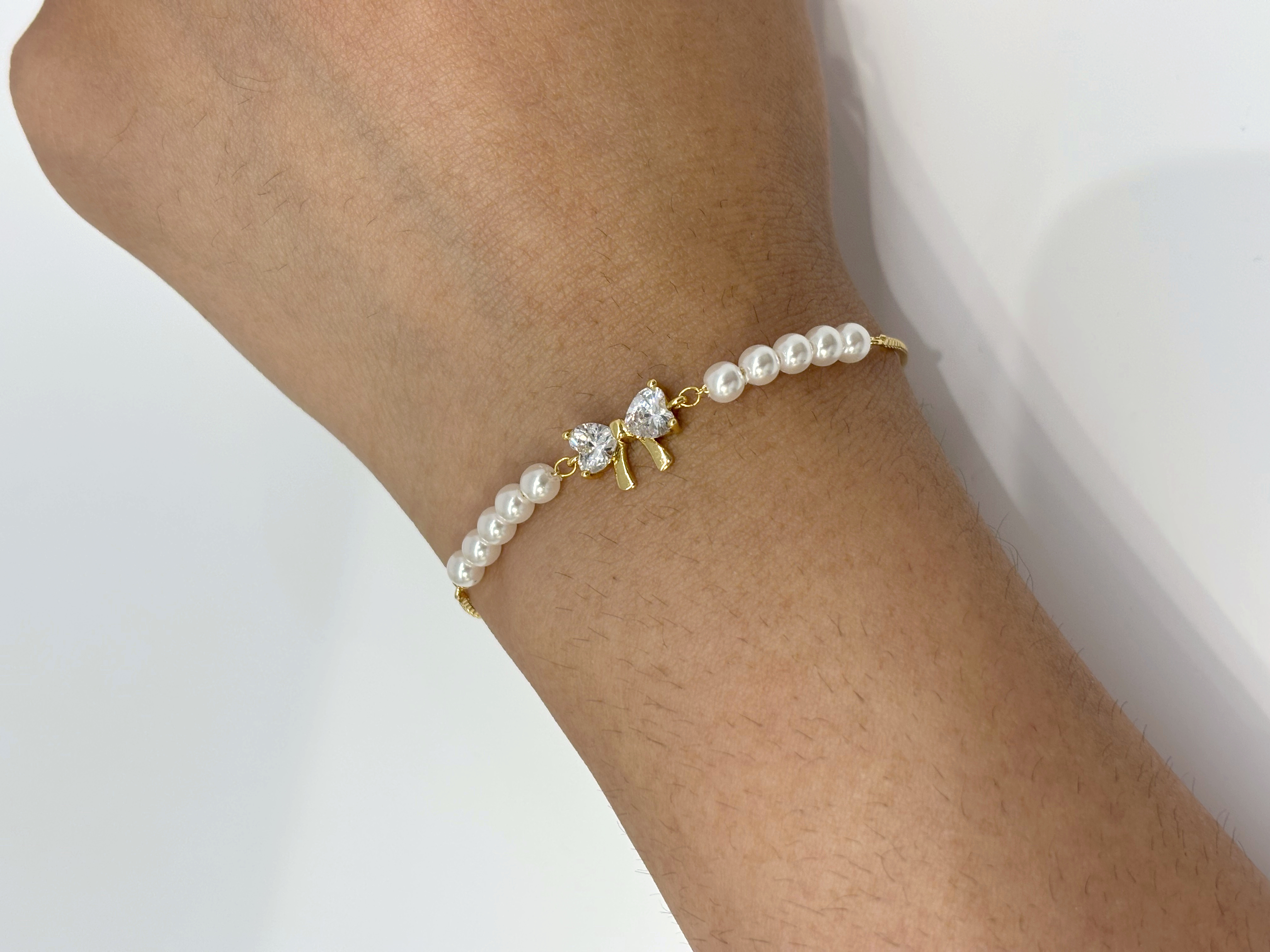 Crystal Bow gold plated bracelet worn on wrist