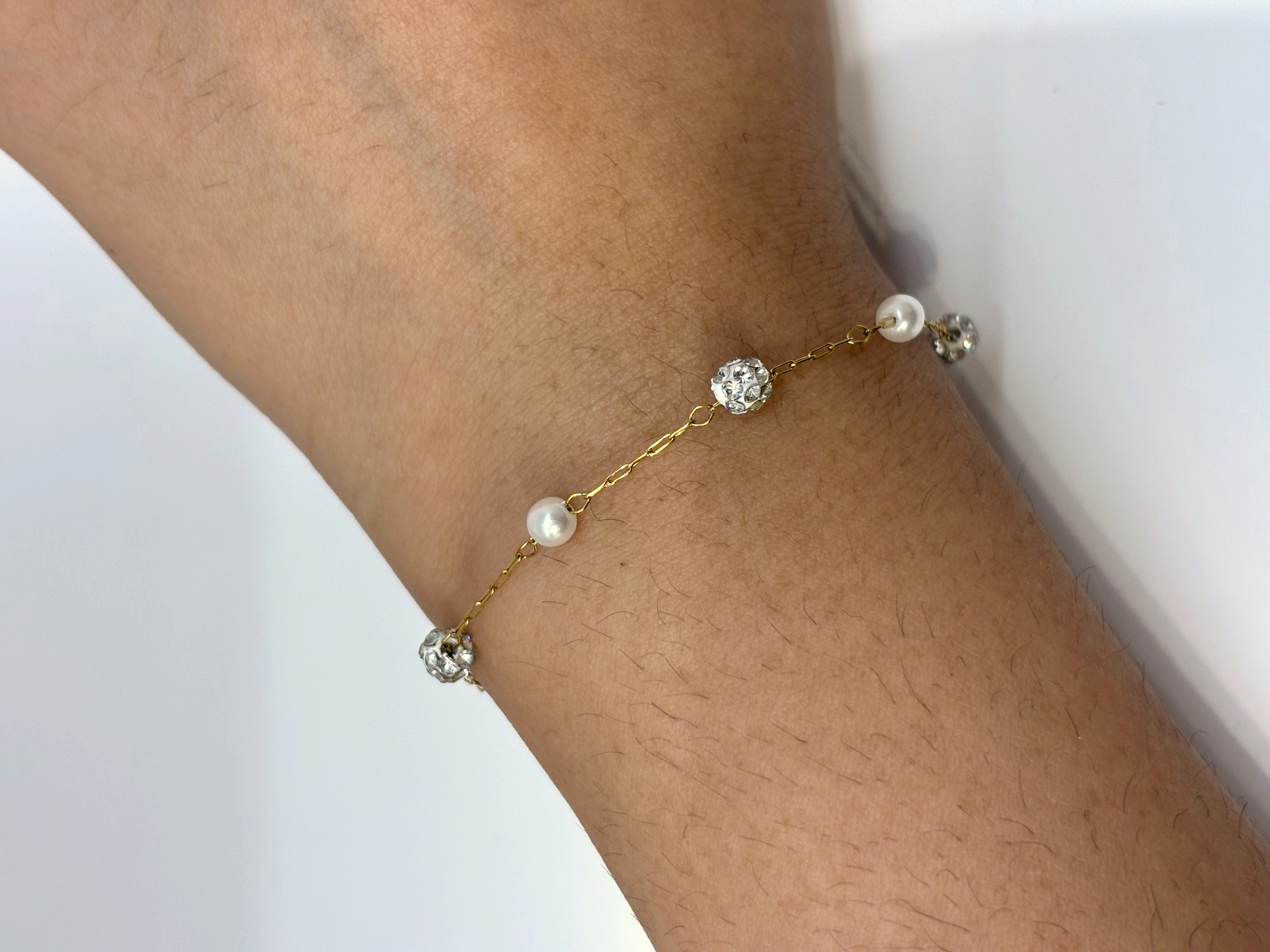 Crystal Station gold plated bracelet worn on wrist