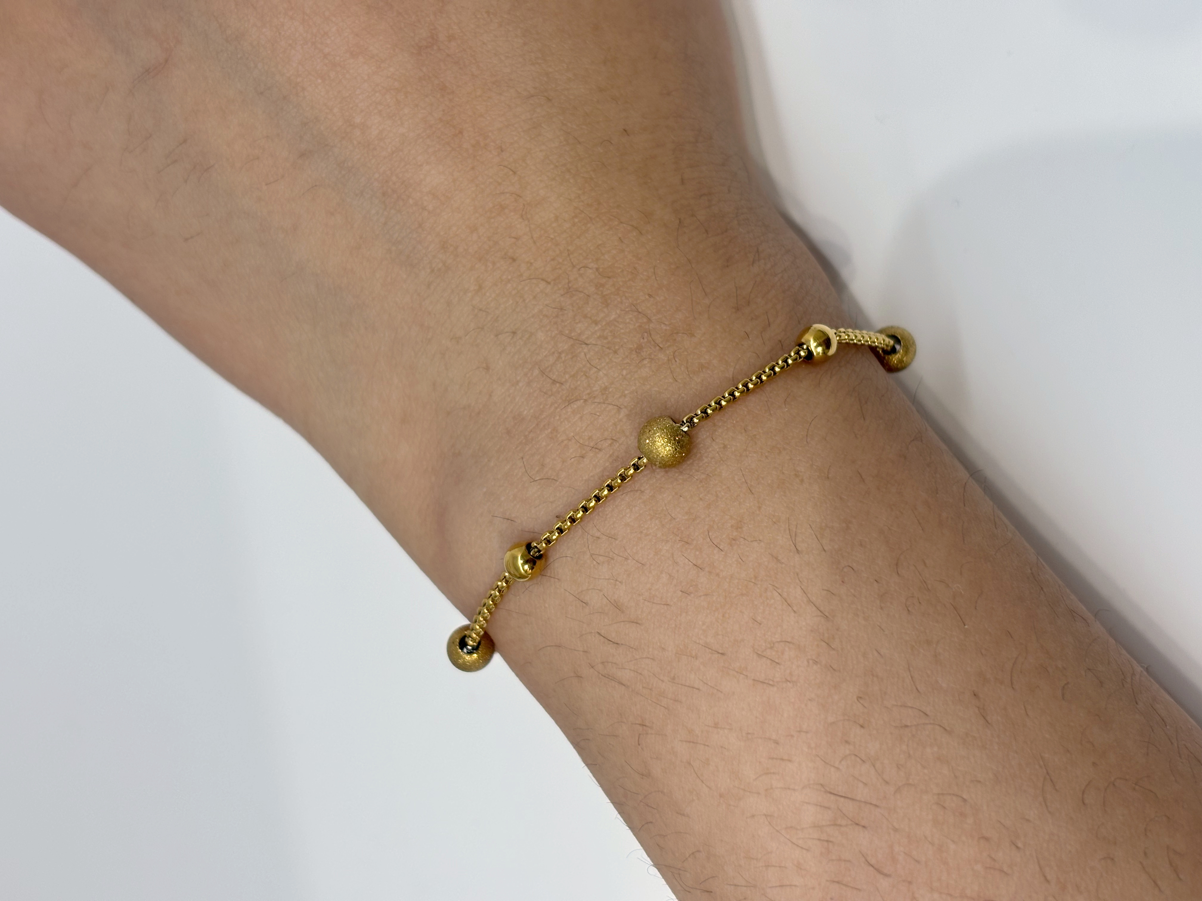 Disc Station gold plated bracelet worn on wrist