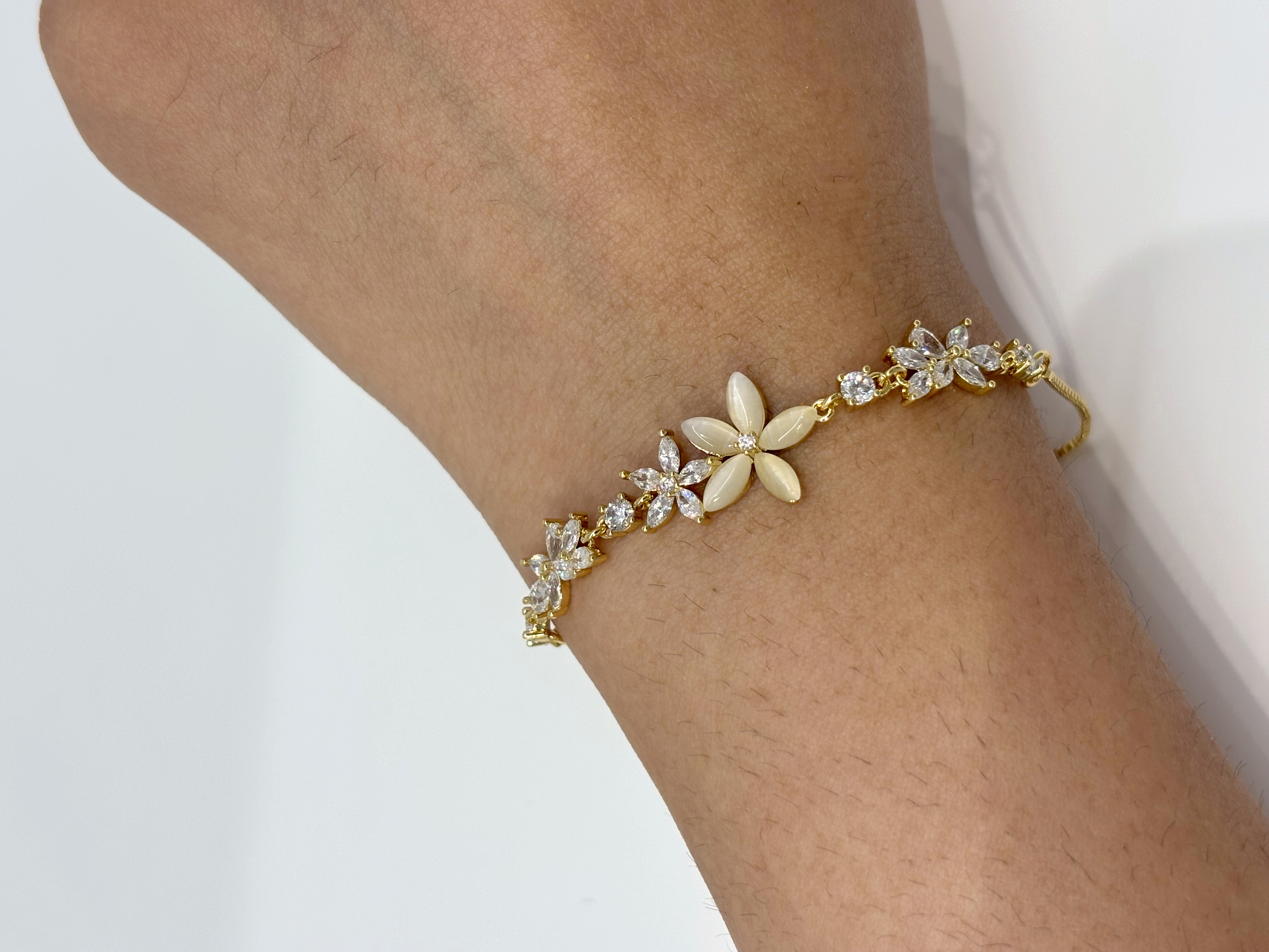 Five Flower Crystal gold plated bracelet worn on wrist