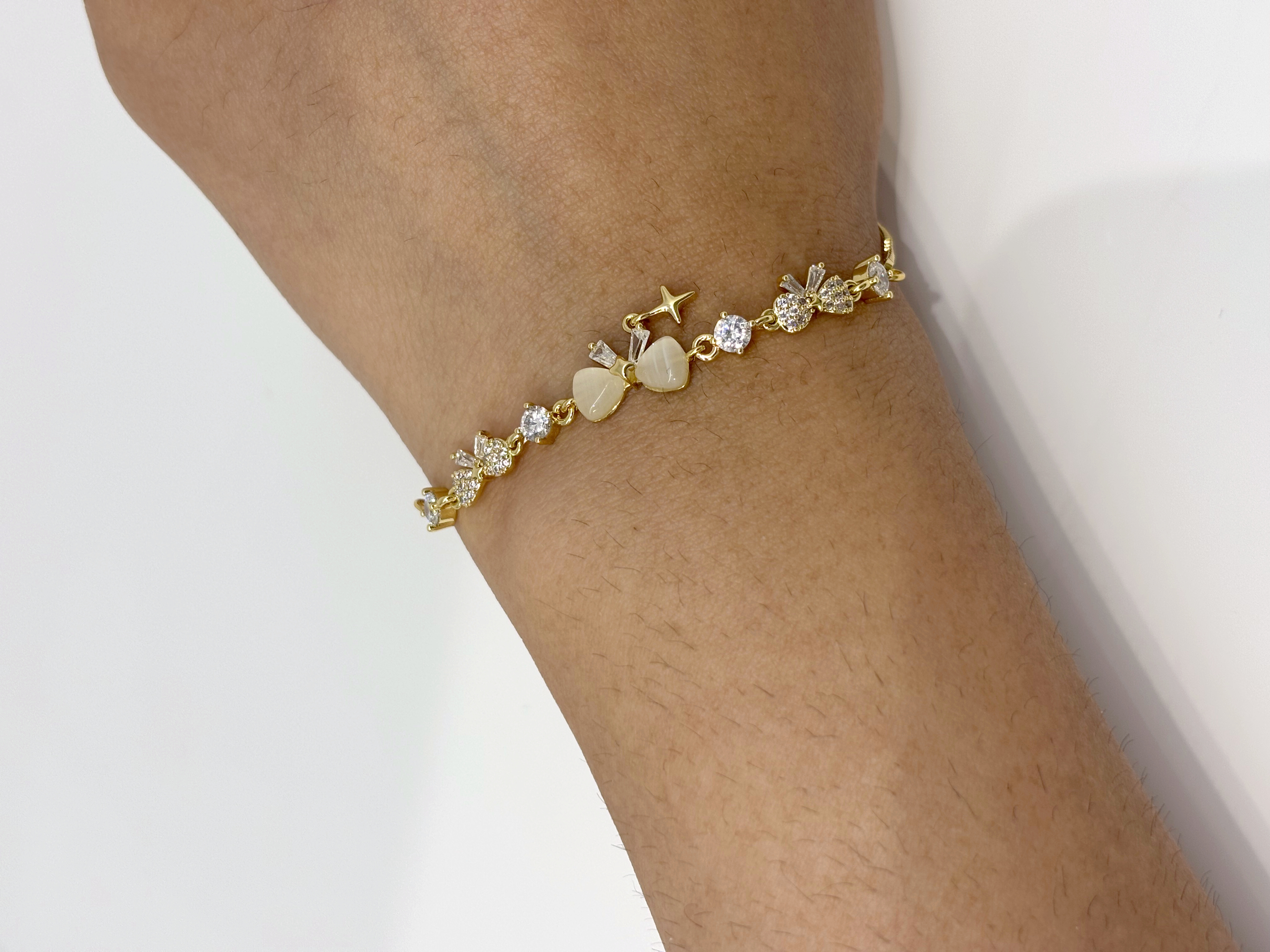Floral Drop gold plated bracelet worn on wrist