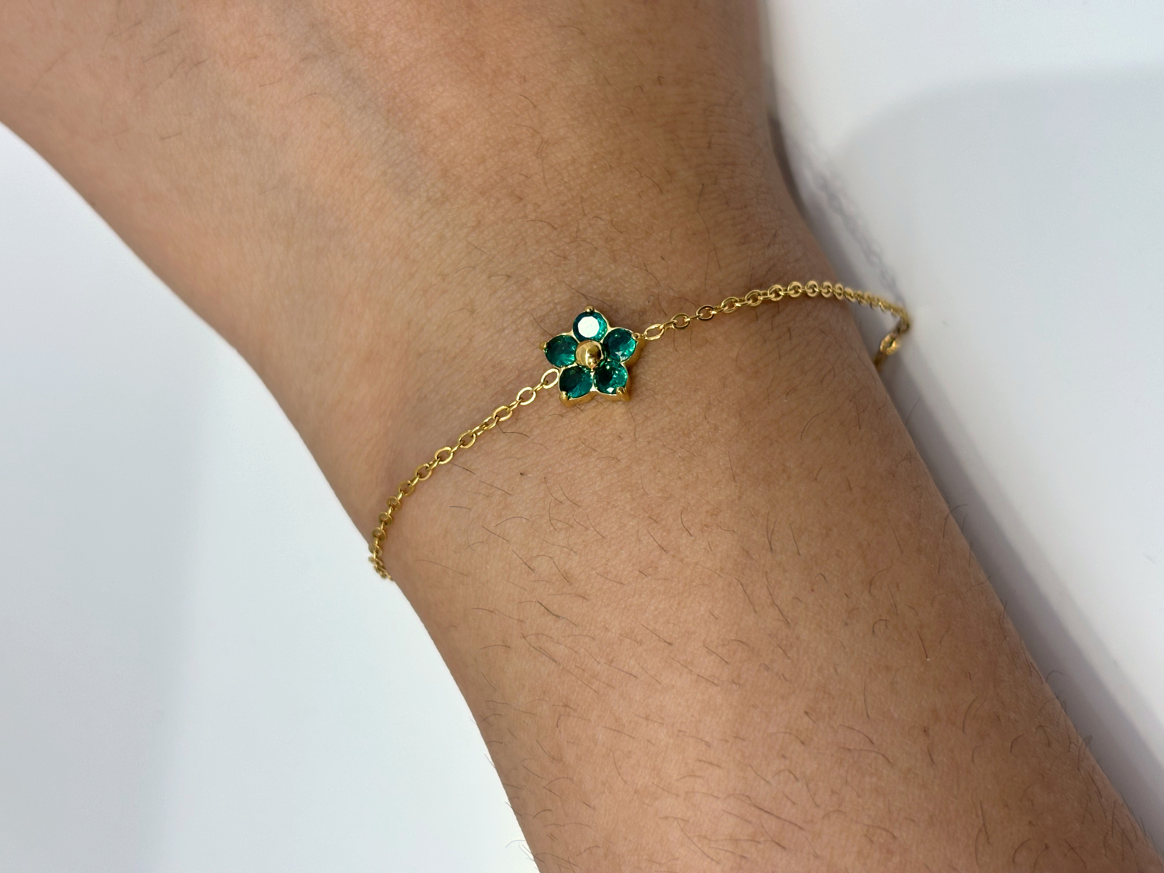 Green Clover gold plated bracelet worn on wrist