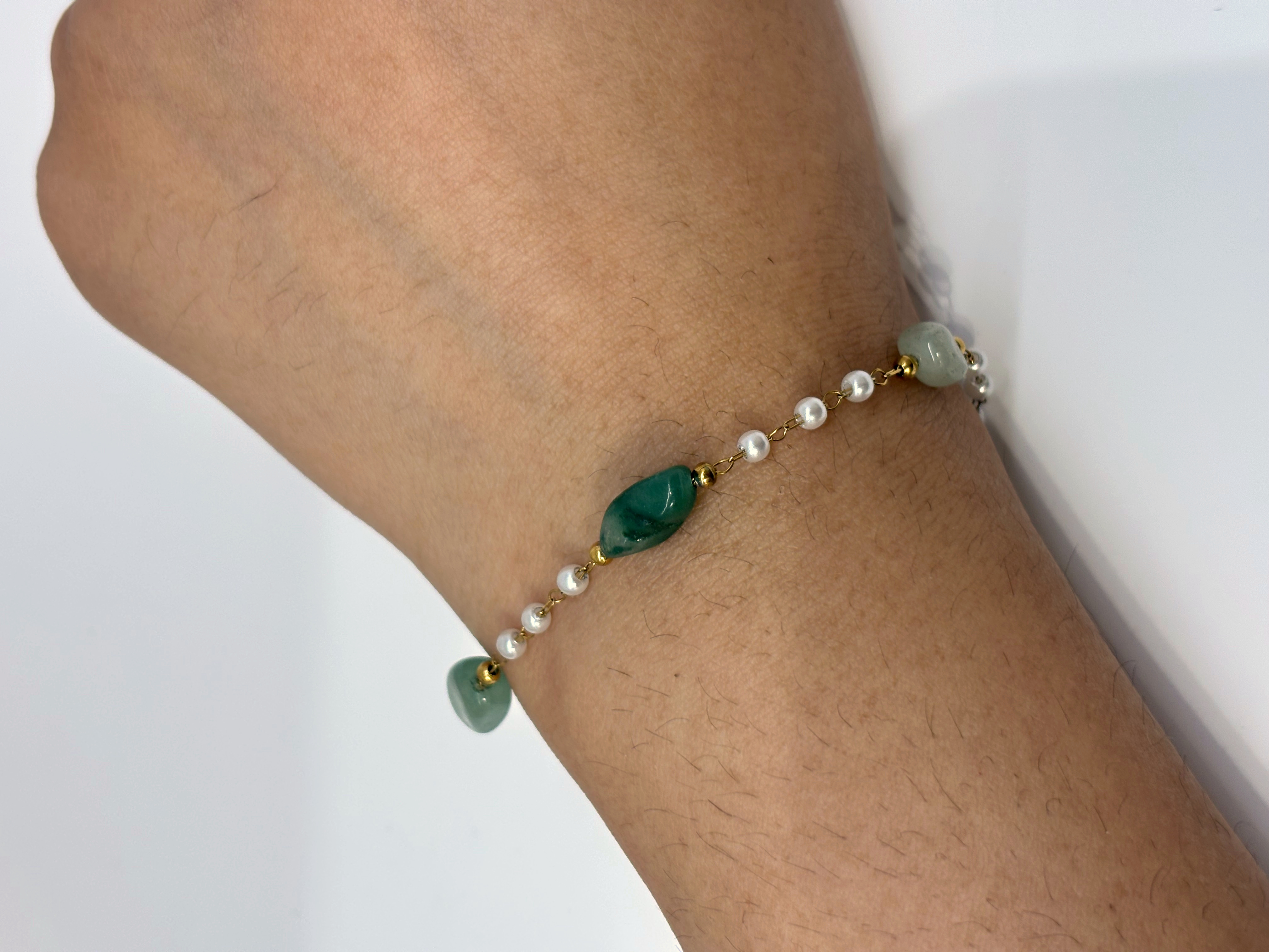 Green Stone Station gold plated bracelet worn on wrist