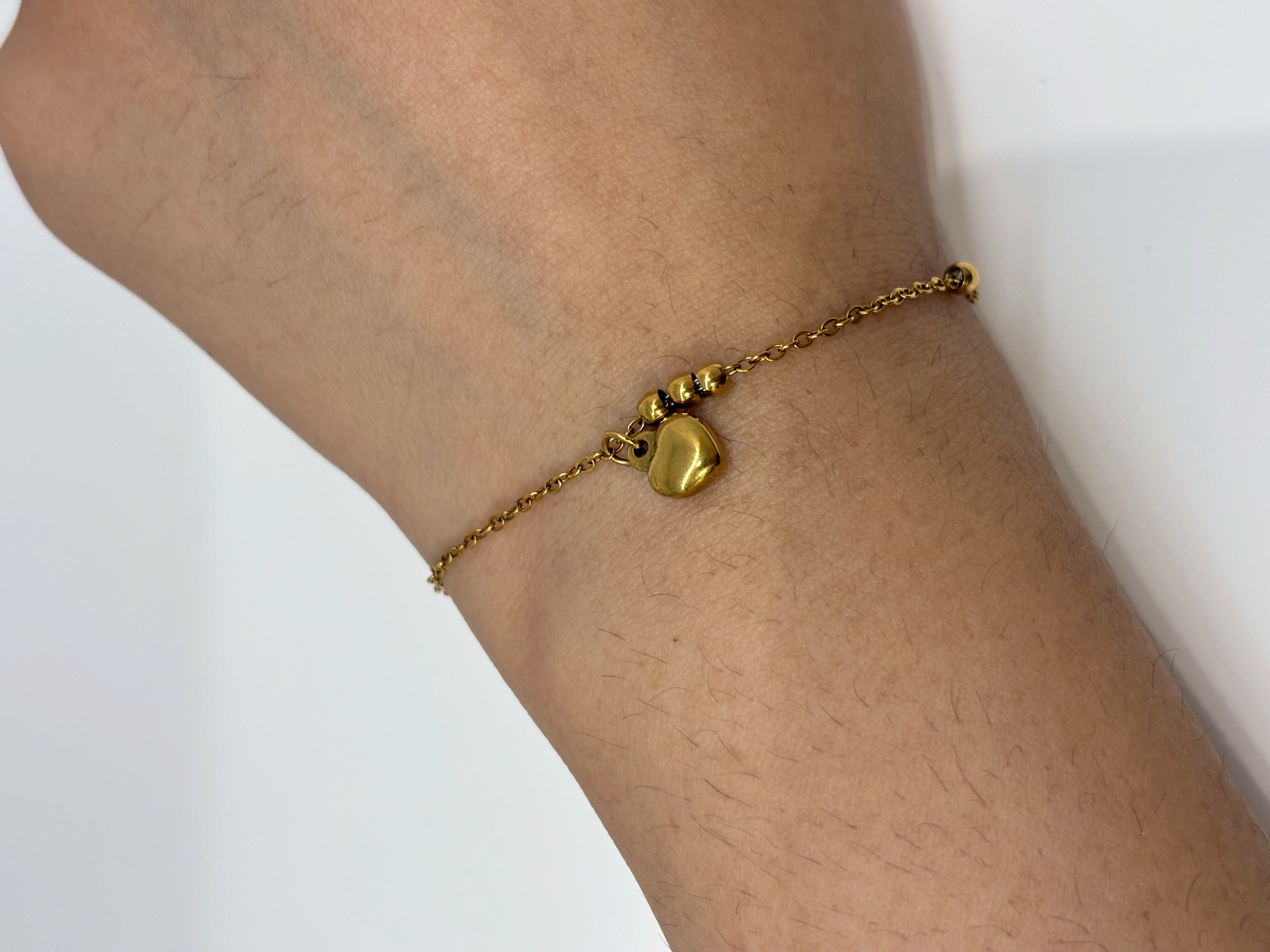 Heart Charm gold plated bracelet worn on wrist