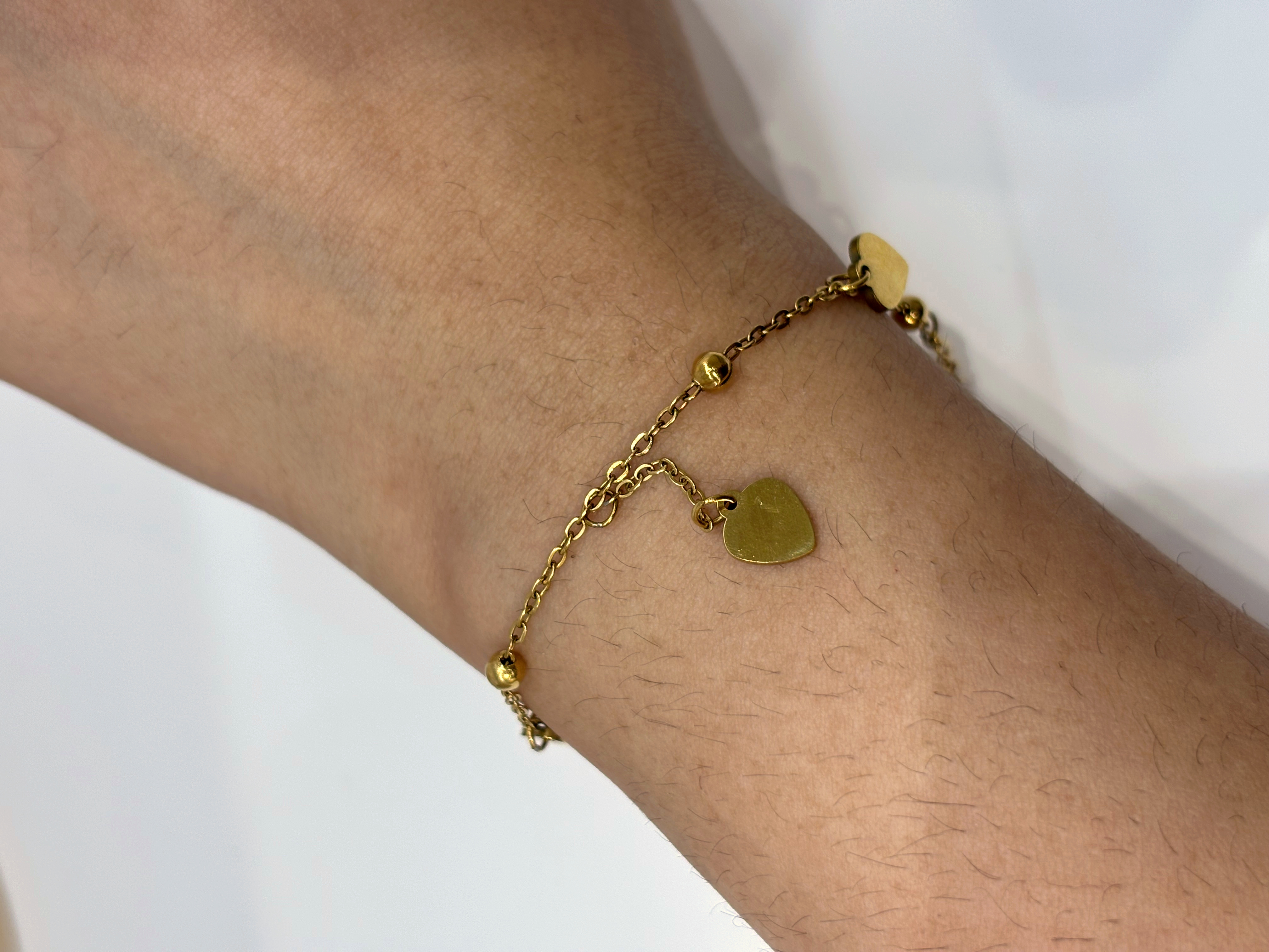 Heart Drop gold plated bracelet worn on wrist