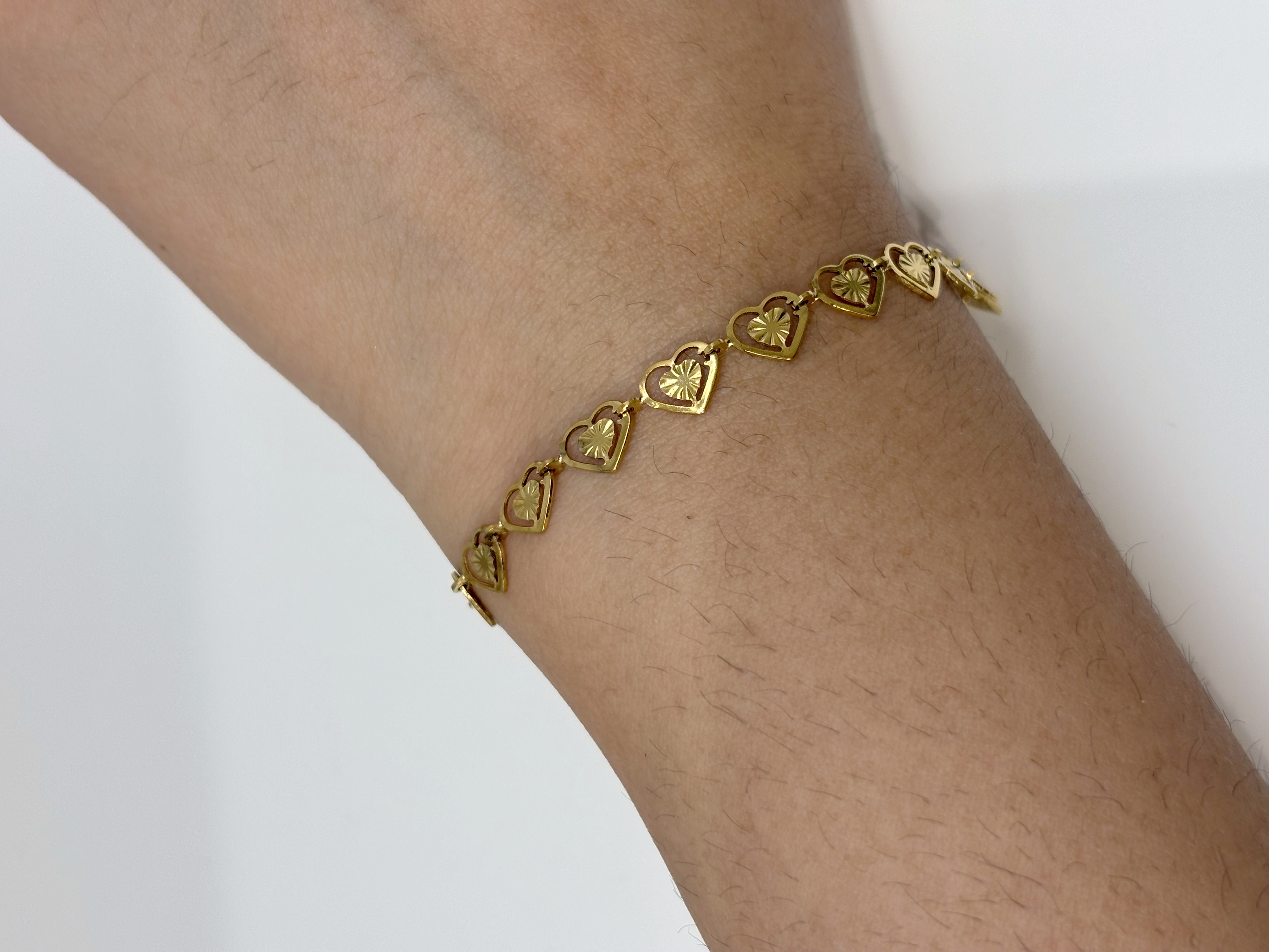 Heart Link gold plated bracelet worn on wrist