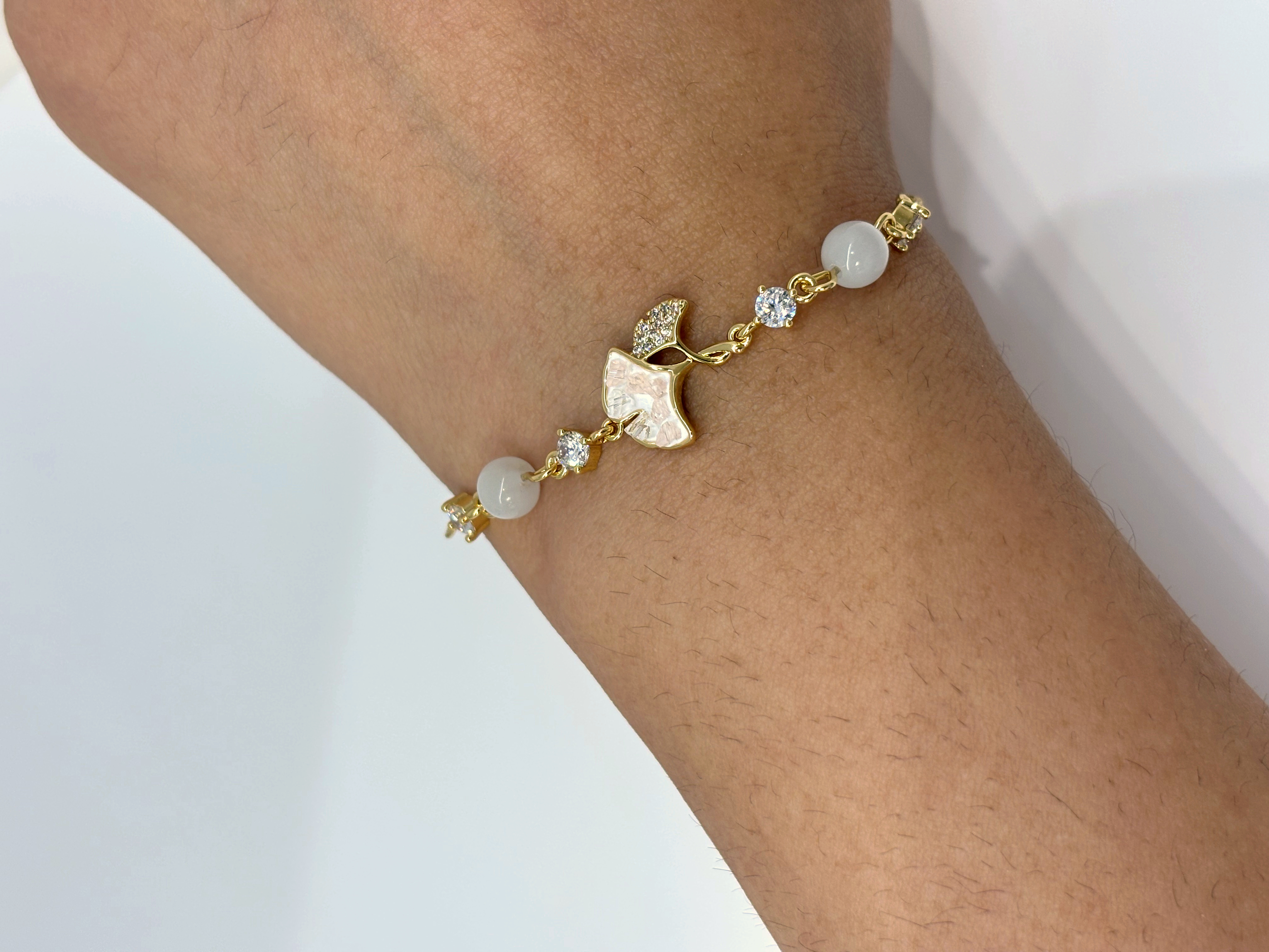 Leaf and Pearl gold plated bracelet worn on wrist