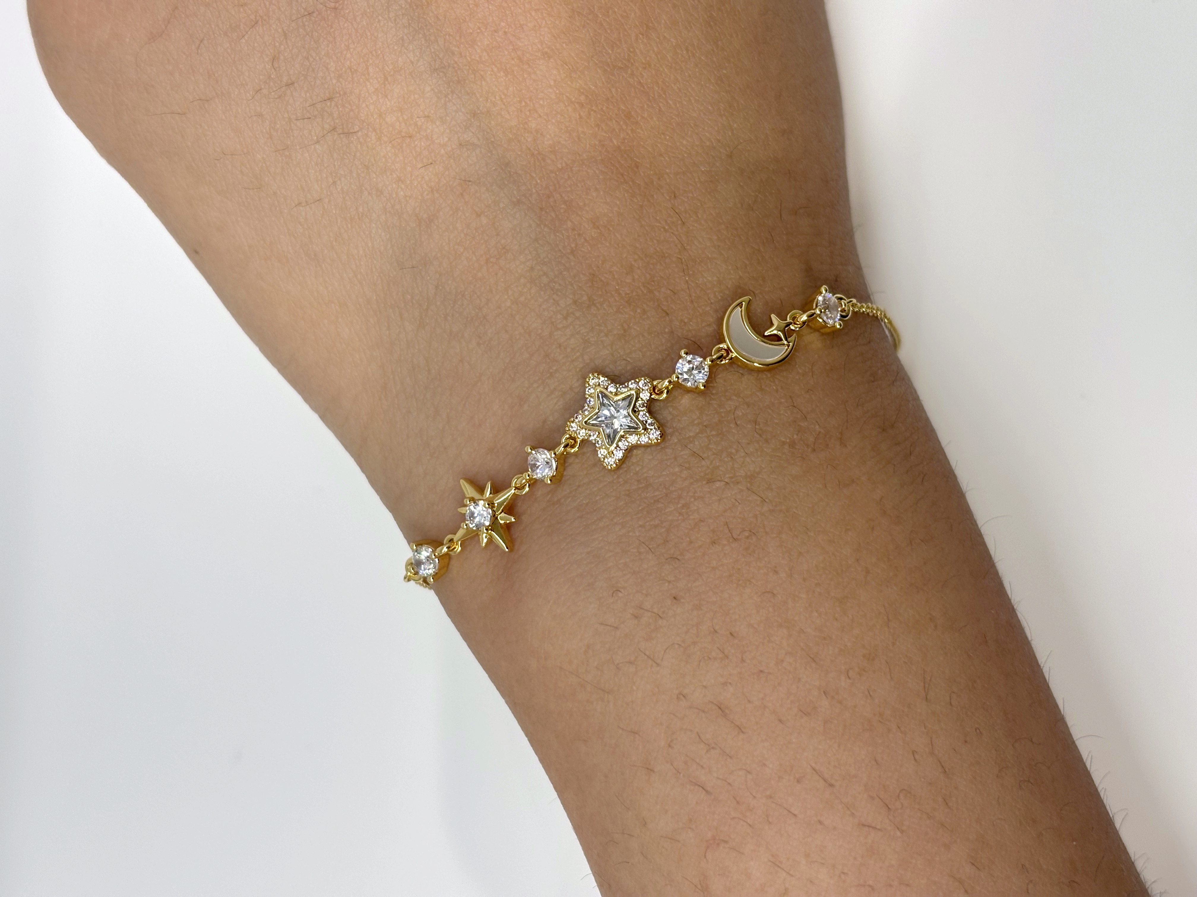 Moon and Star gold plated bracelet worn on wrist