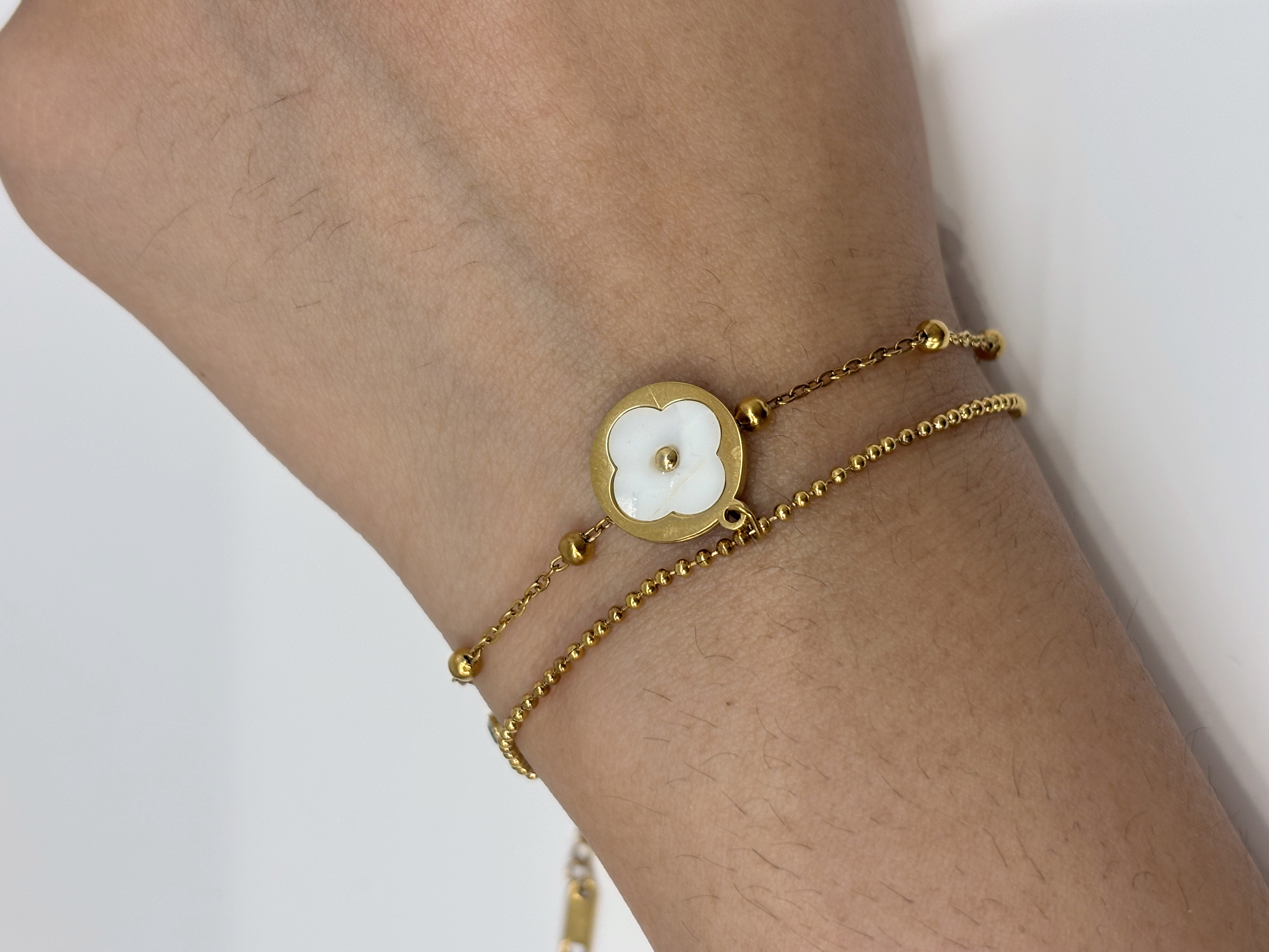 Mother-of-Pearl Flower gold plated bracelet worn on wrist