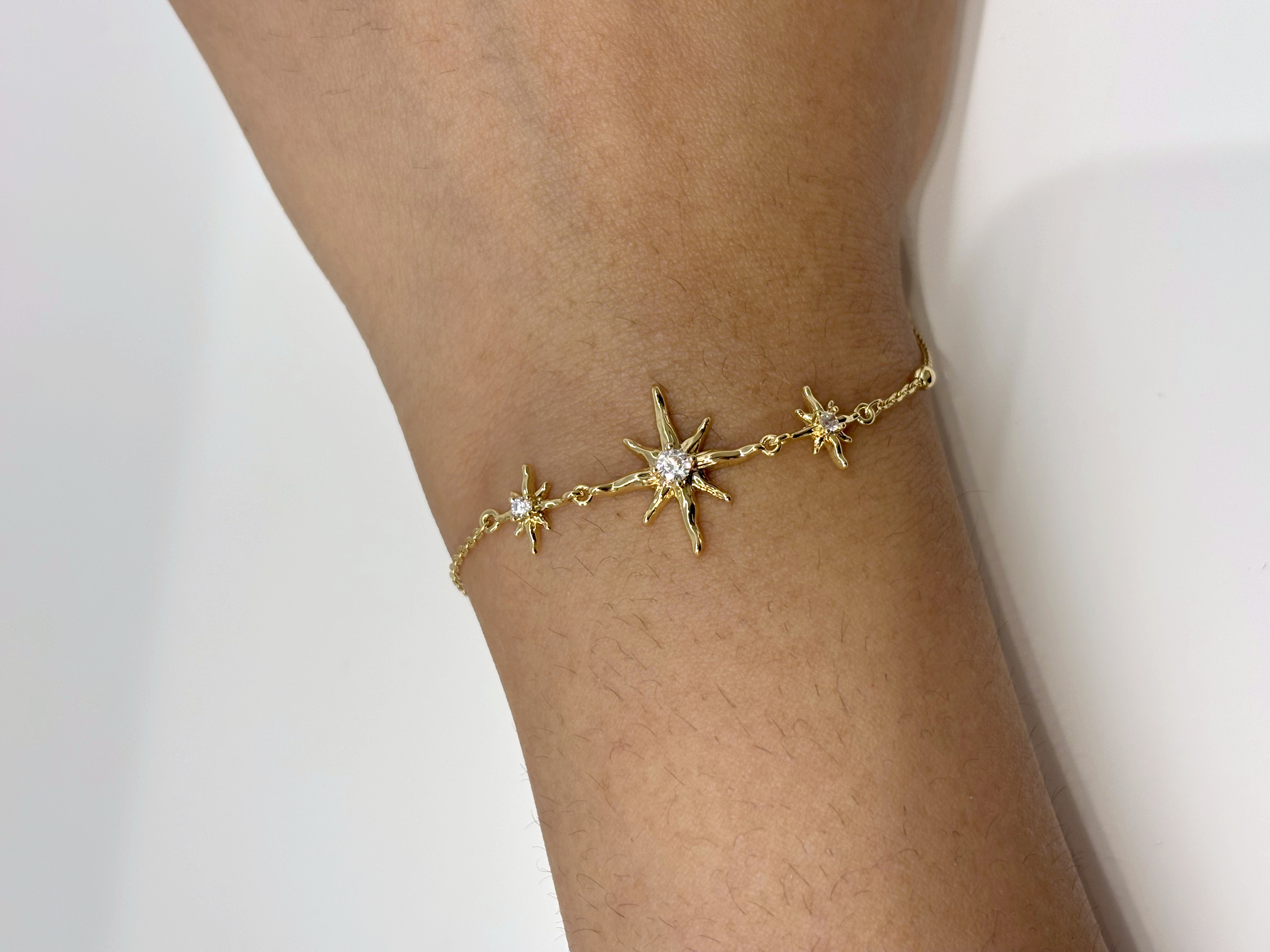 North Star gold plated bracelet worn on wrist