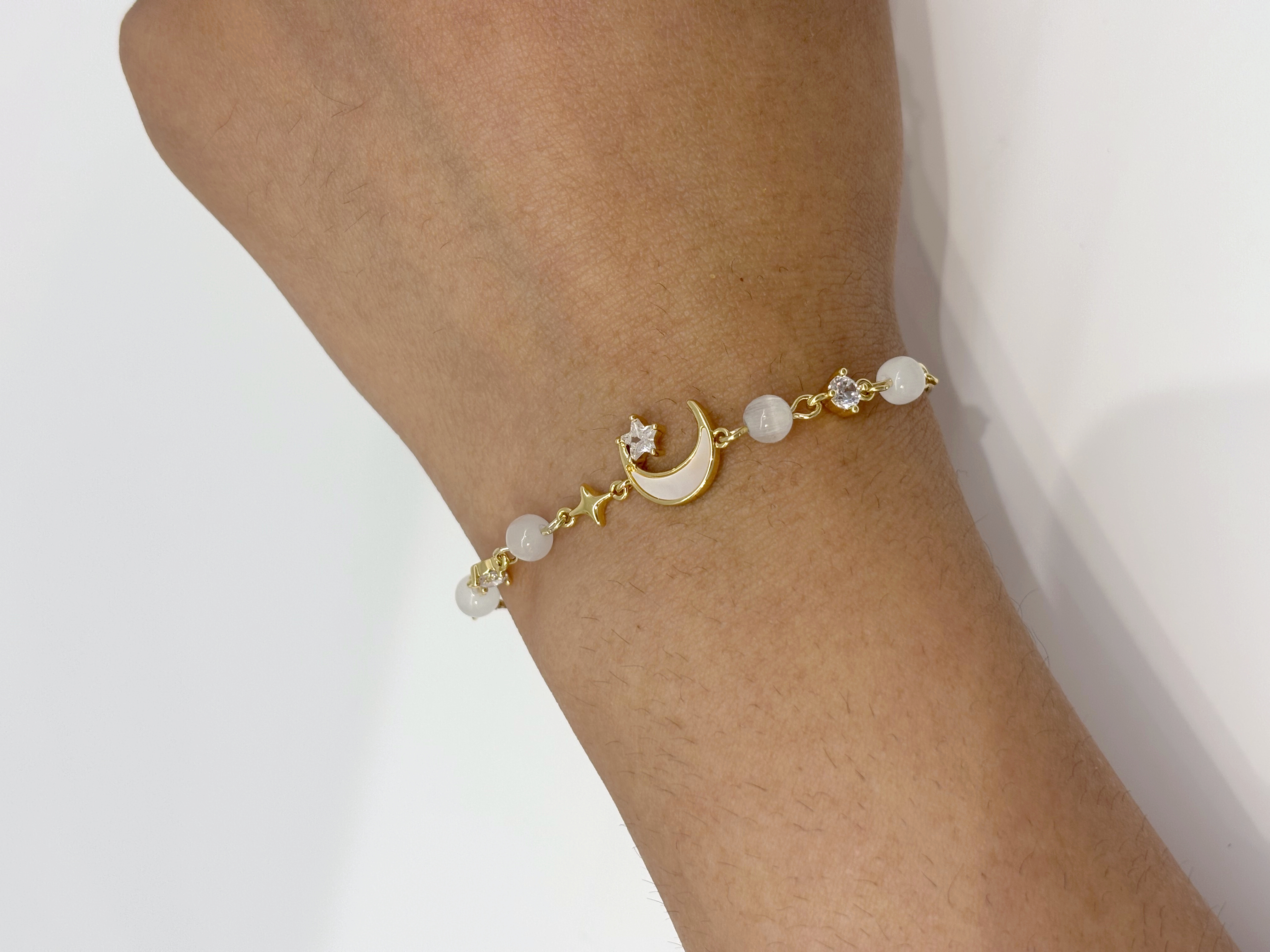 Pearl Crescent Moon gold plated bracelet worn on wrist
