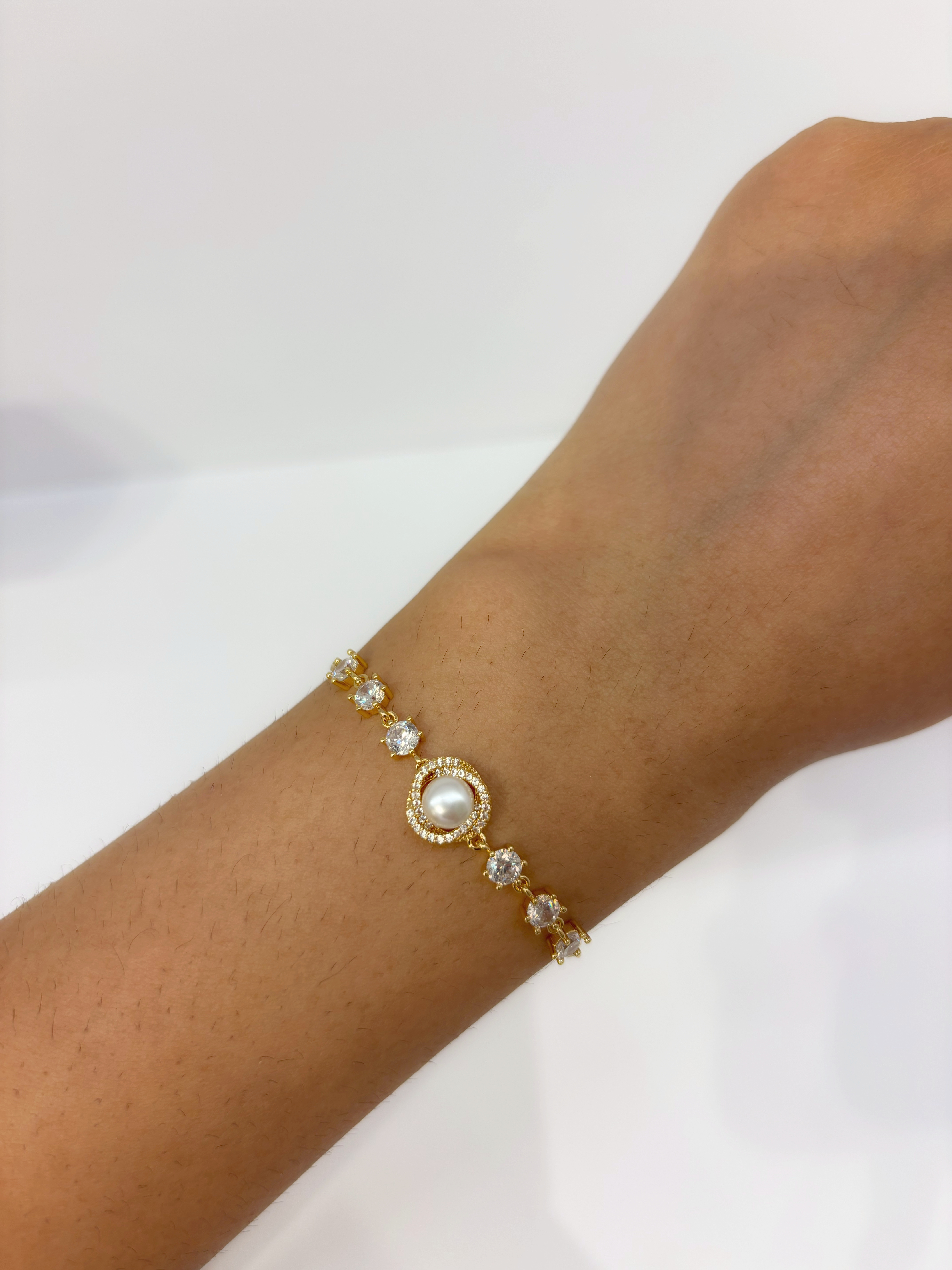 Pearl Halo gold plated bracelet worn on wrist