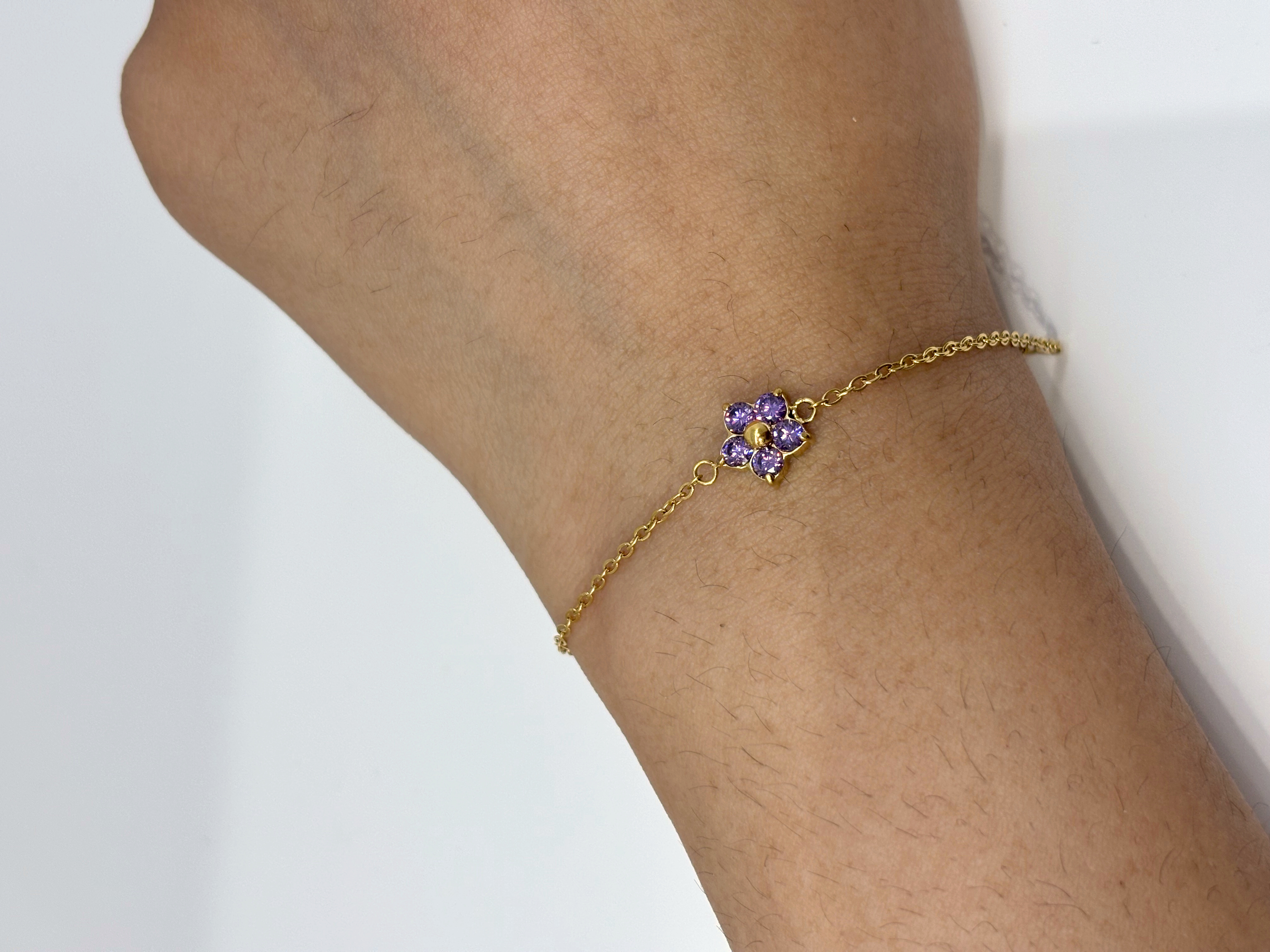 Purple Clover gold plated bracelet worn on wrist