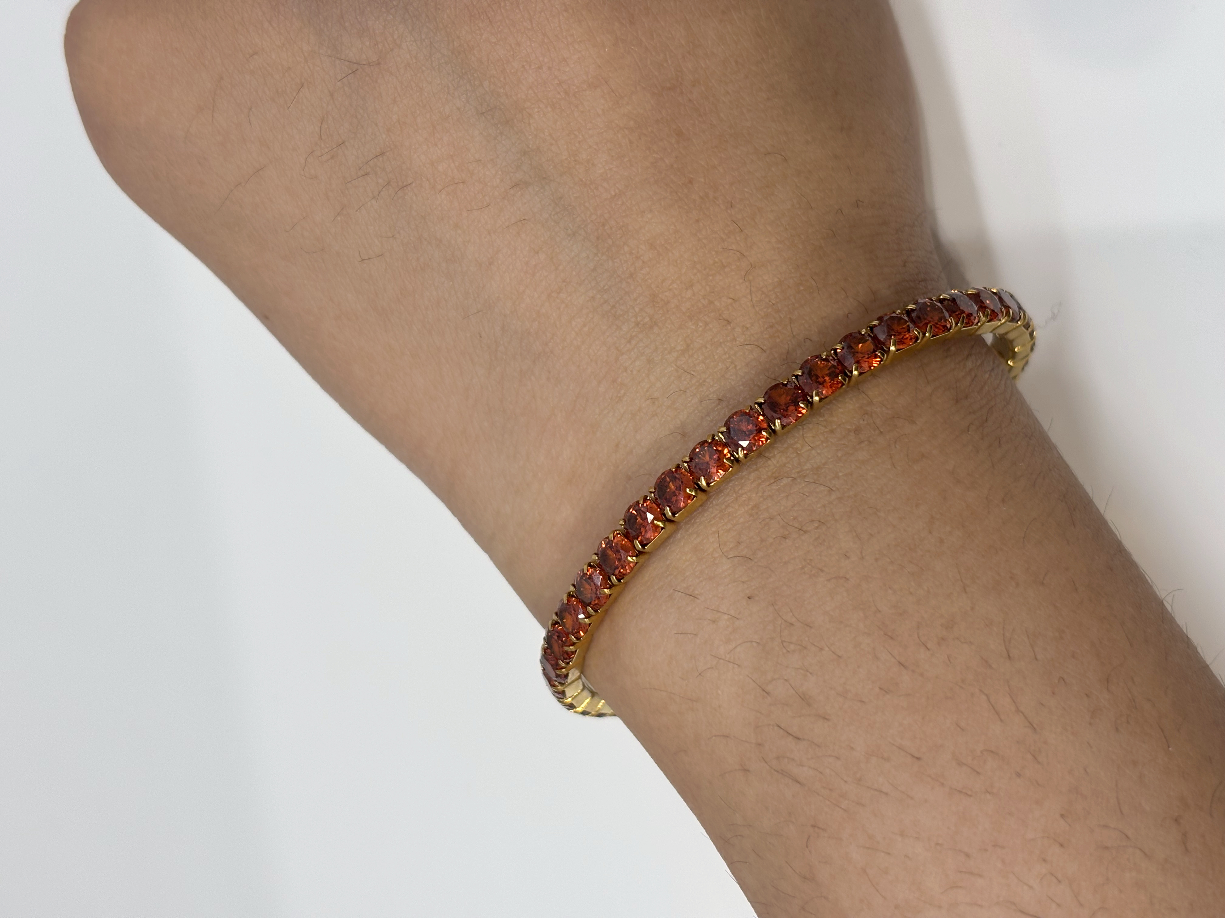 Red Crystal Tennis gold plated bracelet worn on wrist