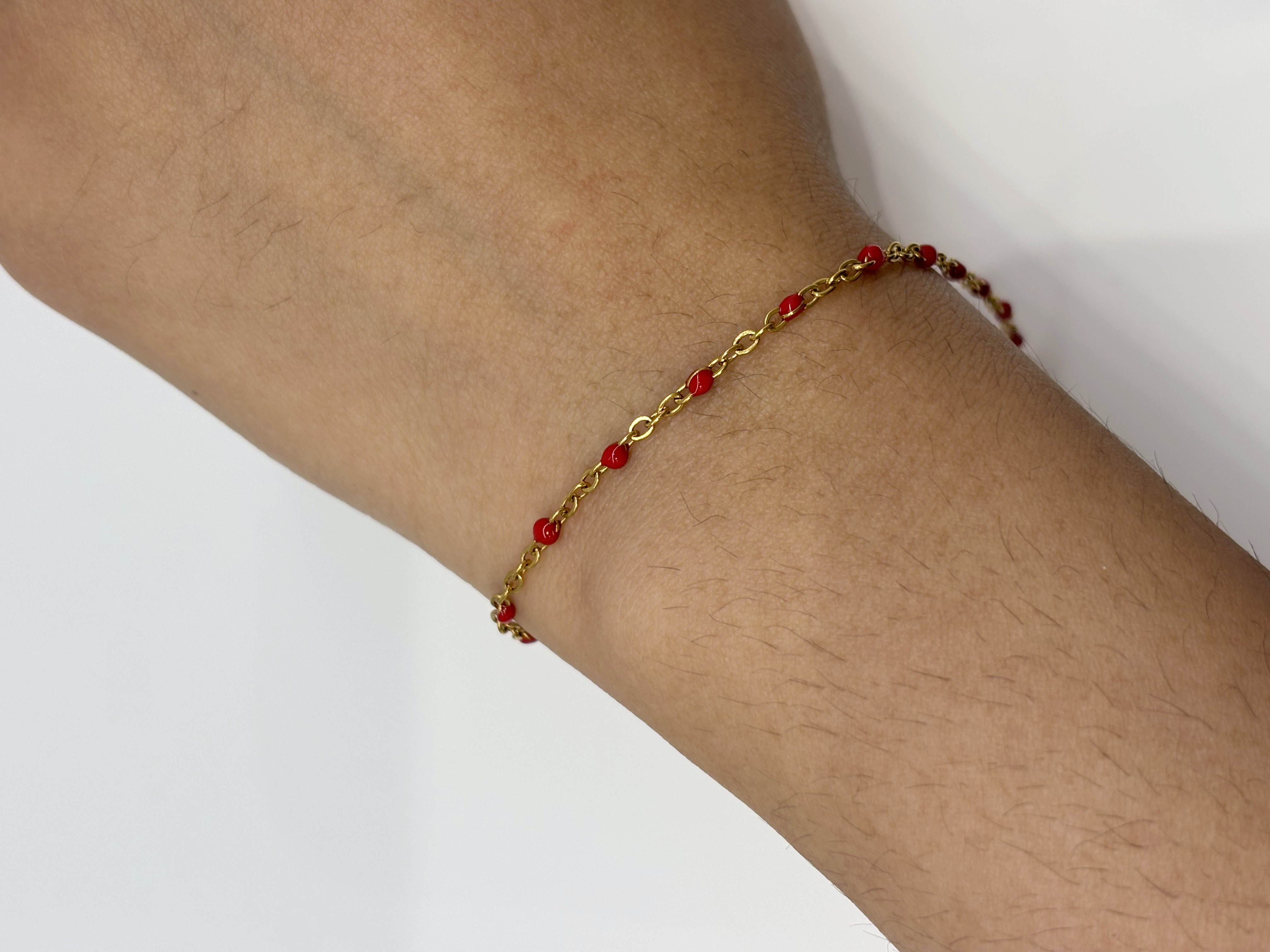 Ruby Bead gold plated bracelet worn on wrist