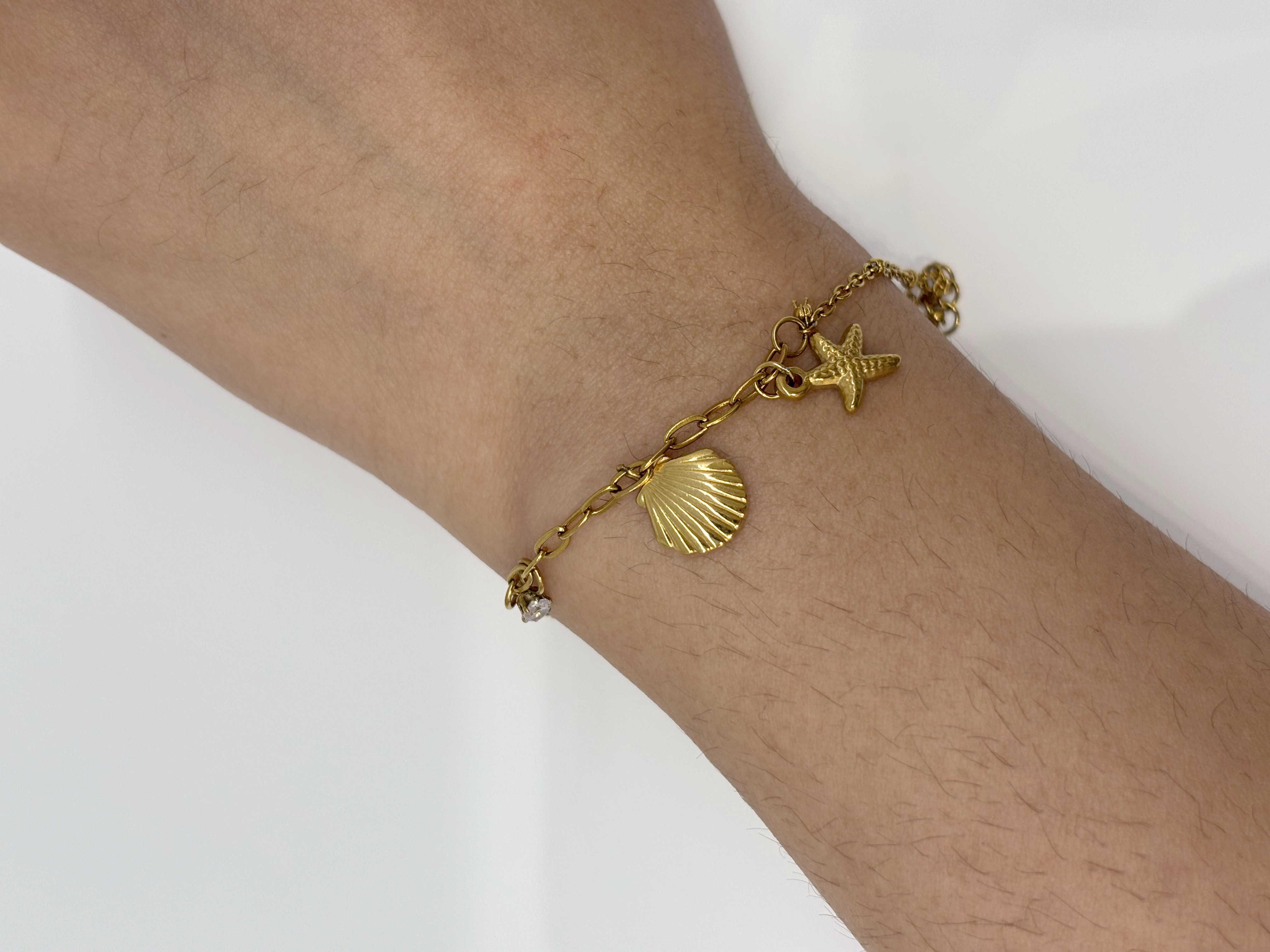Seashell Charm gold plated bracelet worn on wrist