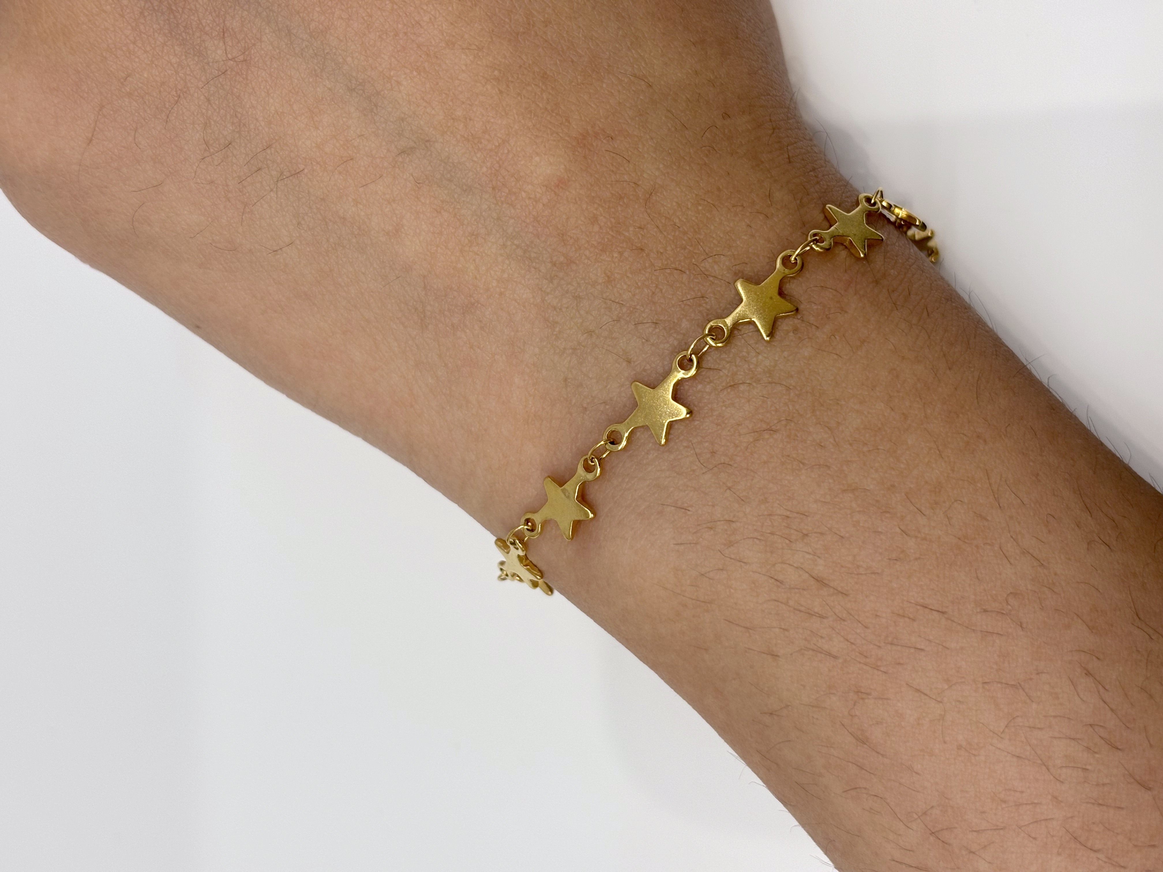 Star Link gold plated bracelet worn on wrist